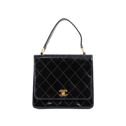 CHANEL quilted flap handle bag