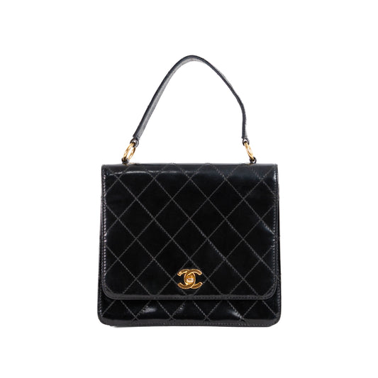 CHANEL quilted flap handle bag